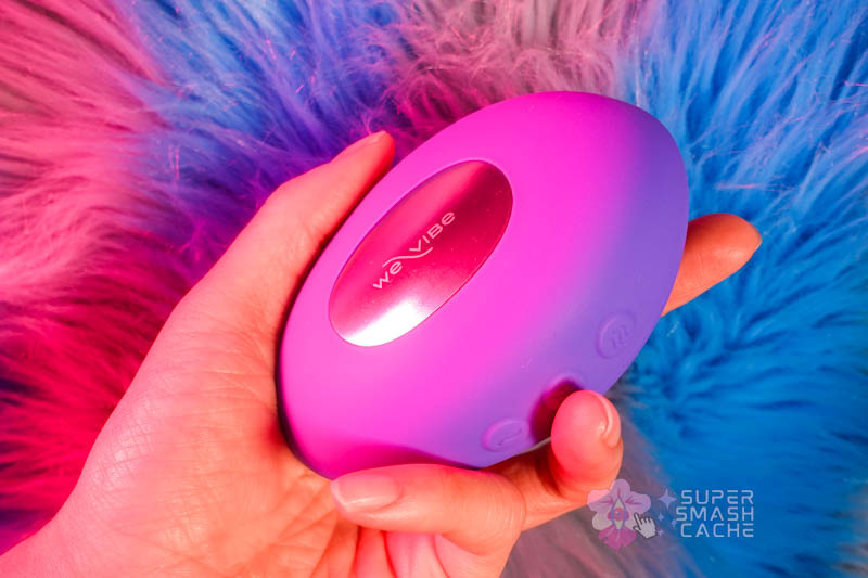 We-Vibe Temp vibrator held in palm showing compact size and ergonomic curve for vulva massage
