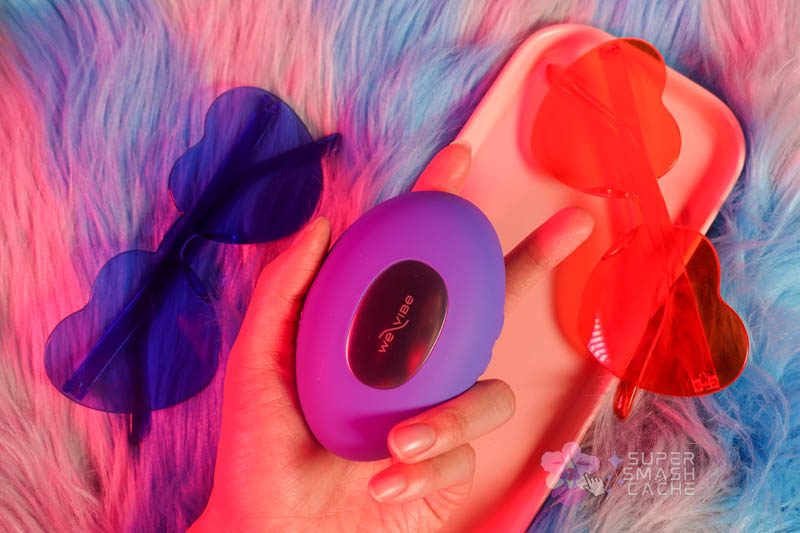 We-Vibe Temp temperature play vibrator with warming and cooling metal plate in hand, blue silicone body, compact pebble shape