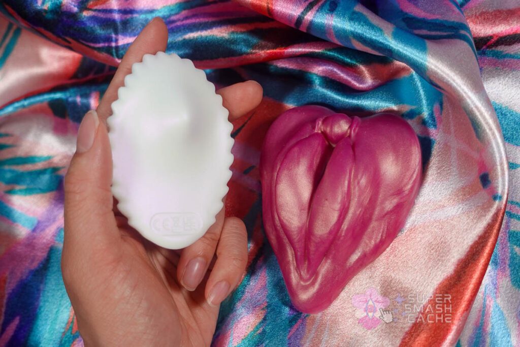 Honey Play Box Pearl 2 seashell-shaped panty vibrator top view showing hump and hand size comparison