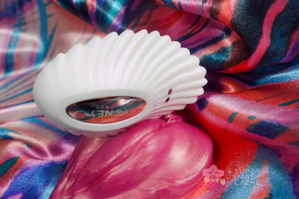 Honey Play Box Pearl 2 seashell-shaped vibrator scalloped edges along silicone vulva-shaped grinder