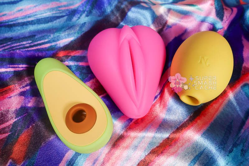 Nancy Avo & Lem Clit Toy Review: high performers or hype? 6 Nancy Avo avocado-shaped air pulse massager next to Bananapants Lippi and Nancy Lem lemon-shaped suction vibrator