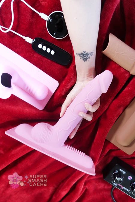 Riding the $1,000 Motorbunny Original, Sybian, and Tremor saddle vibrators broke my brain 21 Holding an 8-inch long Sybian and Motorbunny dildo attachment
