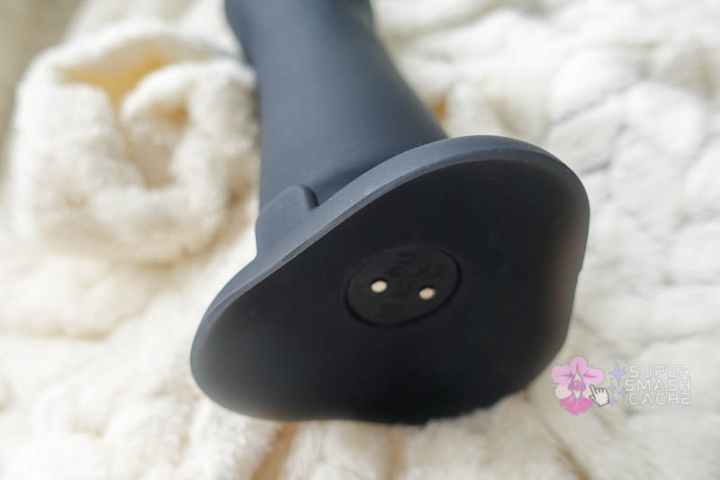 b-vibe fisting dildo base showing vibrator charging contact, suction cup dip, and orientation node