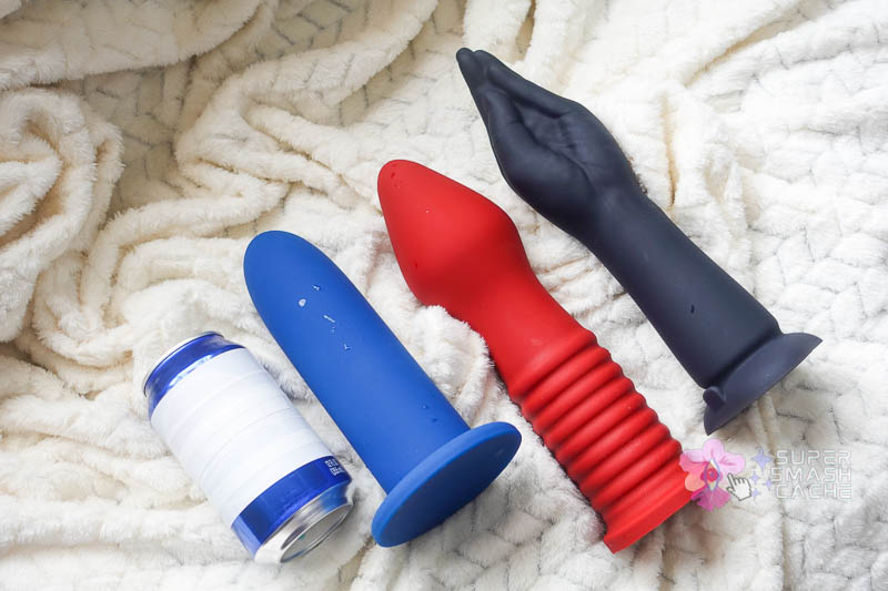 size comparison: b-vibe 10.5" silicone fisting vibrating dildo vs. tantus fist trainer vs. vwell superfit XL dilator vs. soda can